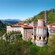 A large multi story sanctuary with a bell tower built into the edge of a mountain